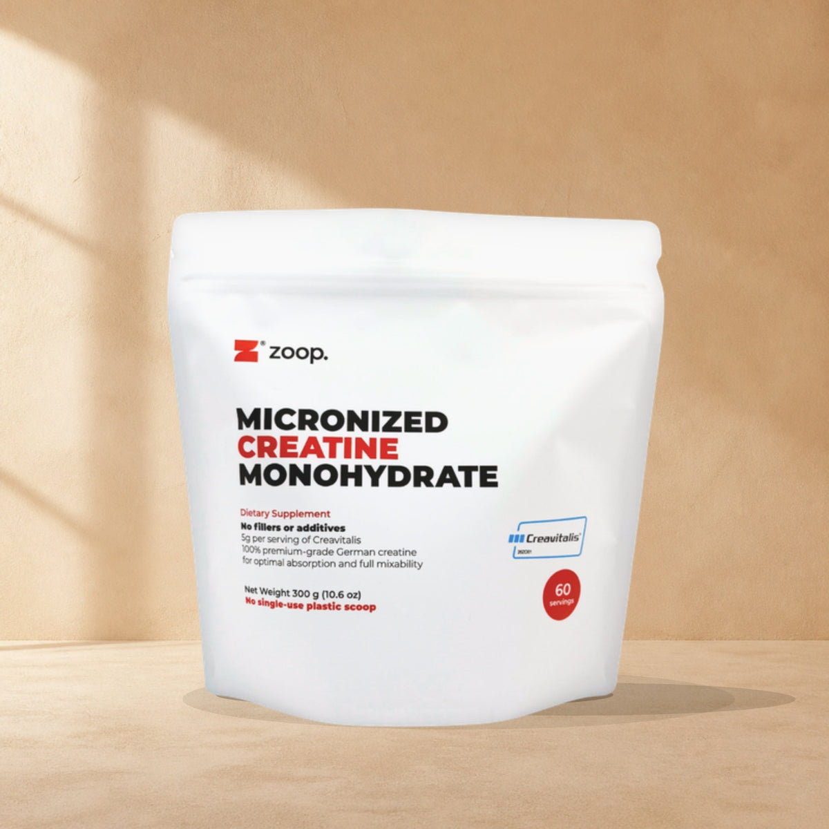 ZOOP. Creavitalis creatine pouch on a warm sand studio backdrop