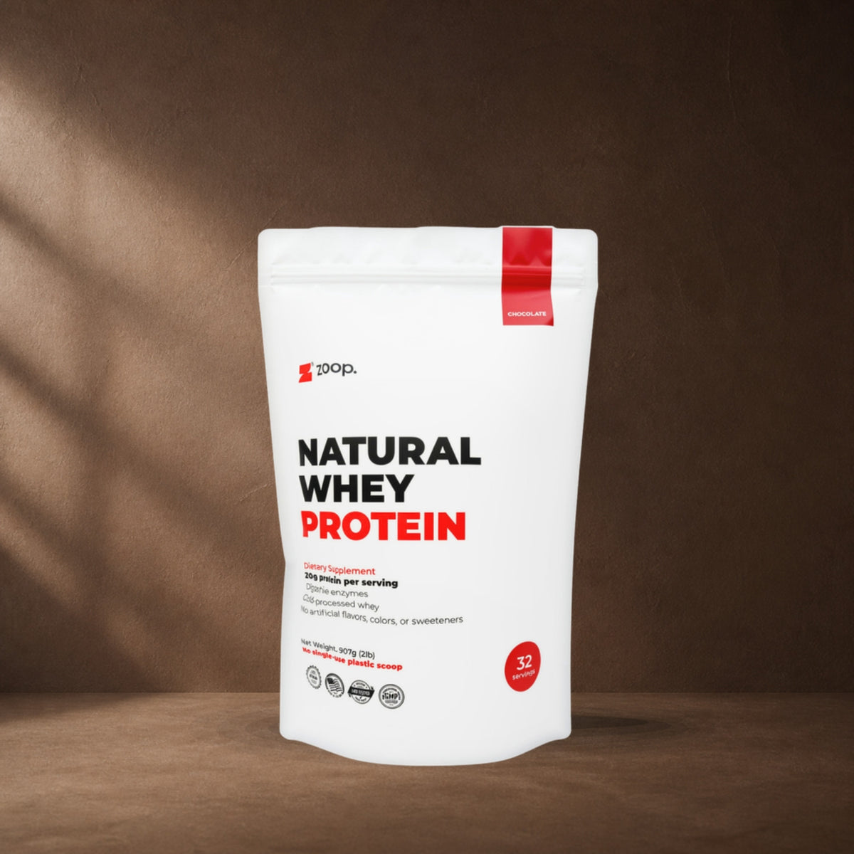 ZOOP. Natural Whey Protein chocolate pouch on a cocoa studio backdrop